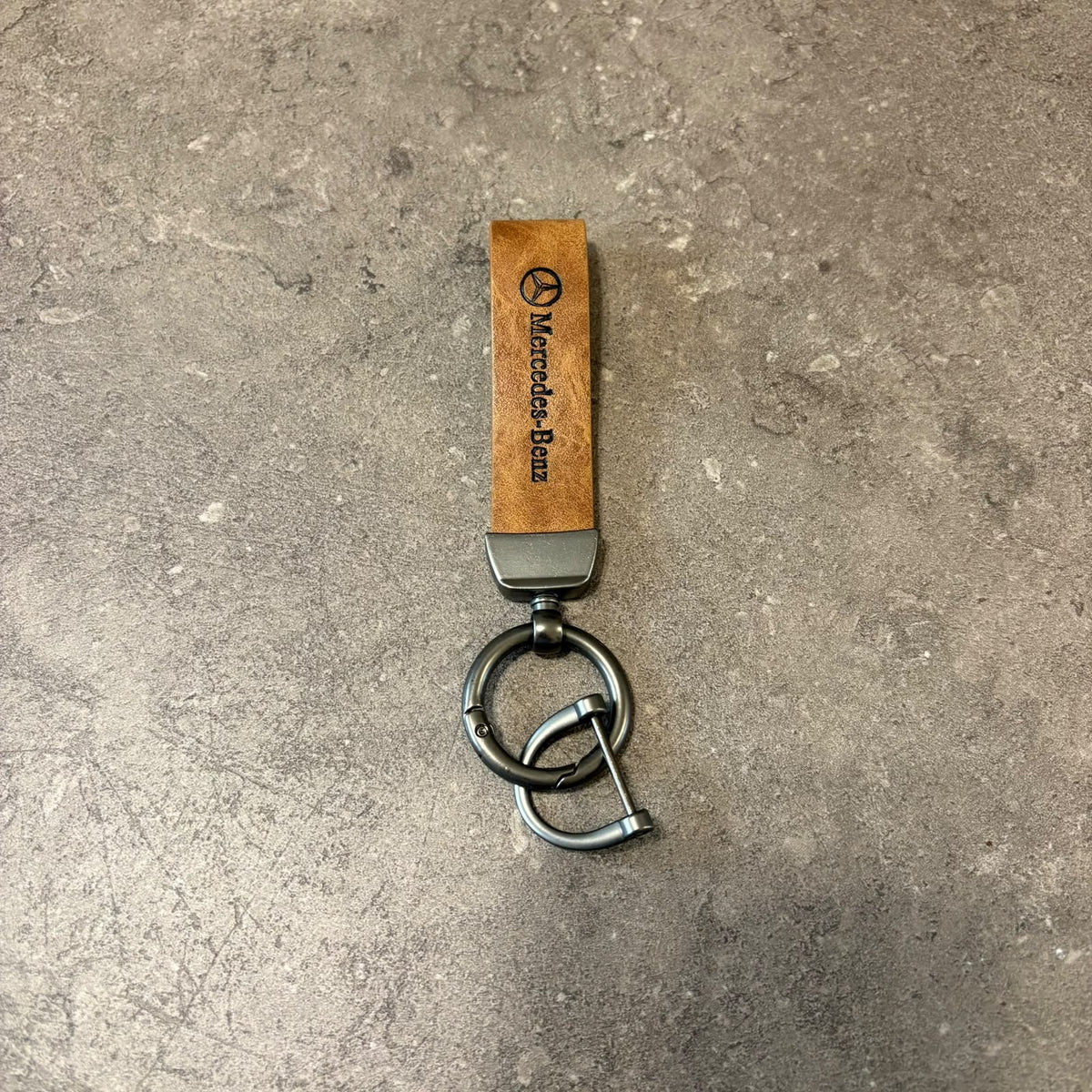Classic Tan Leather Car Keychain featuring a Mercedes strap and dark metallic keyring hardware.