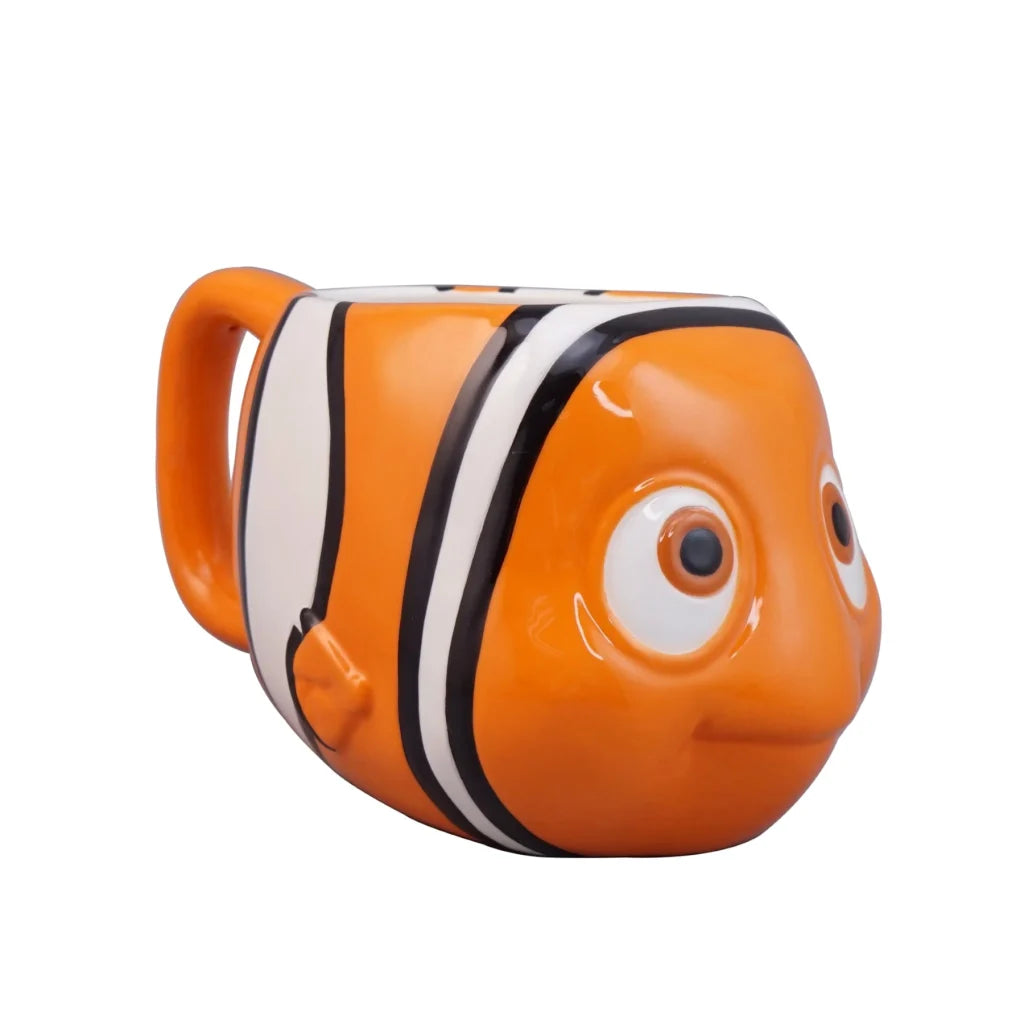 An orange clownfish-shaped ceramic mug with white and black stripes, featuring a large cartoon eye on the side, shown against a plain white background.