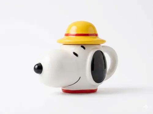 A ceramic teapot shaped like Snoopy wearing a yellow hat with a red band, on a clean white background.