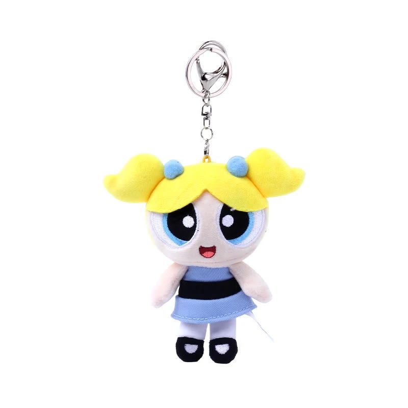 Plush keychain of a cartoon character with yellow hair and blue dress on a white background