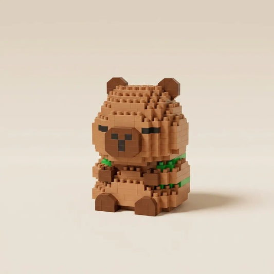 A small capybara figurine built from tan and brown micro-bricks, with a green collar, standing against a plain warm beige background.