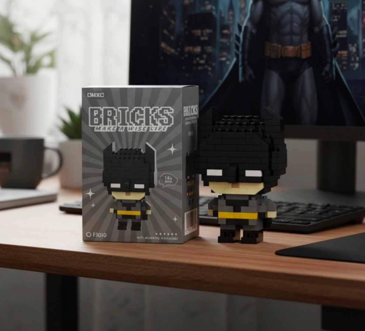 Chibi Batman building block figure displayed on a desk next to keyboard and monitor