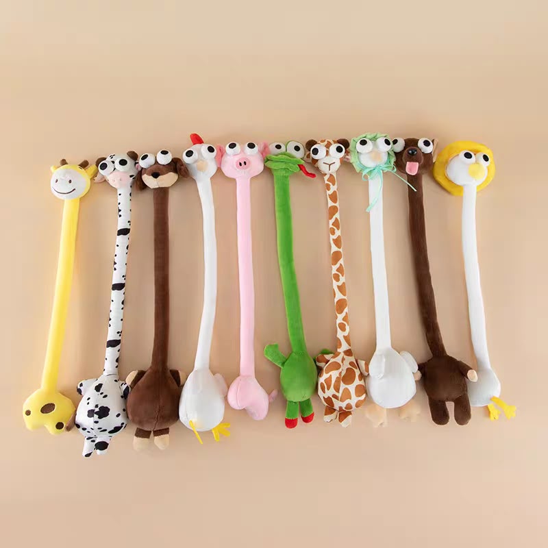 A set of nine plush animal-shaped novelty items arranged in a row against a solid beige background. The items include a giraffe, zebra, donkey, rooster, pig, snake, long-neck giraffe, frog, monkey, and lion, each with a long handle and a small plush animal head.