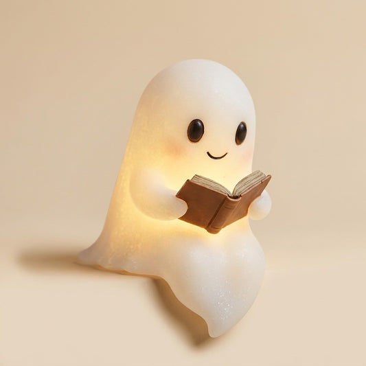 A 3D-printed silicone ghost reading lamp sitting on a shelf with a warm LED glow.