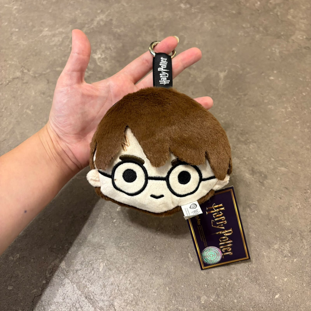 Harry Potter plushie face pouch and bag keychain clip attached to a bag