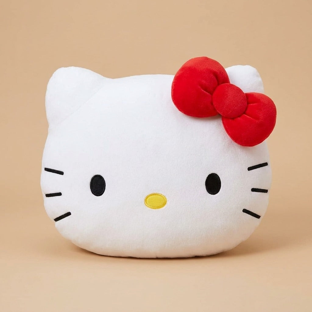 A white Hello Kitty plush cushion with a red bow, black whiskers, and a small yellow nose, photographed against a solid beige background.