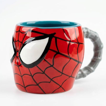 A red Spider-Man themed ceramic mug with a 3D face design, black web pattern, white eyes, and a gray web-handle, shown on a white background.