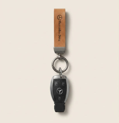 Classic Tan Leather Car Keychain featuring a Mercedes-Benz logo strap and dark metallic keyring hardware.   