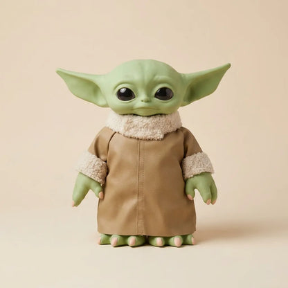 A collectible figurine of Grogu / The Child from The Mandalorian, featuring green skin, large black eyes, and a tan robe with cream sherpa lining, set against a solid beige background.