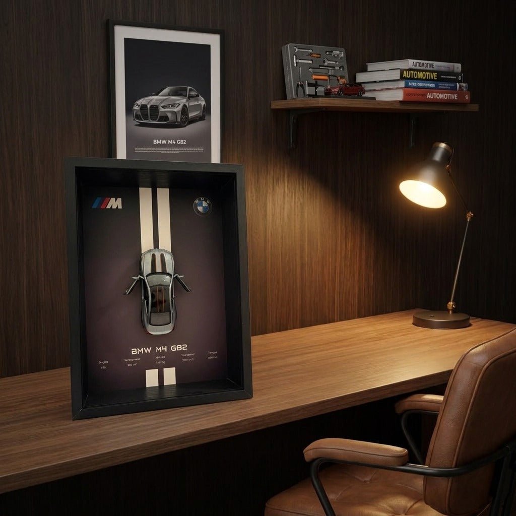 BMW M4 3D Framed Diecast Wall Art in a 32cm x 23cm black shadow box frame, featuring a grey 1:32 scale model car with open doors against an M-Power design background with performance stats.