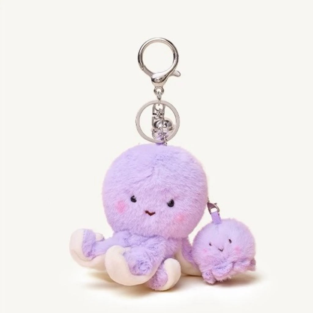 A cute lavender plush octopus keychain with a silver metal key ring and a smaller matching plush companion, shown on a plain off-white background.