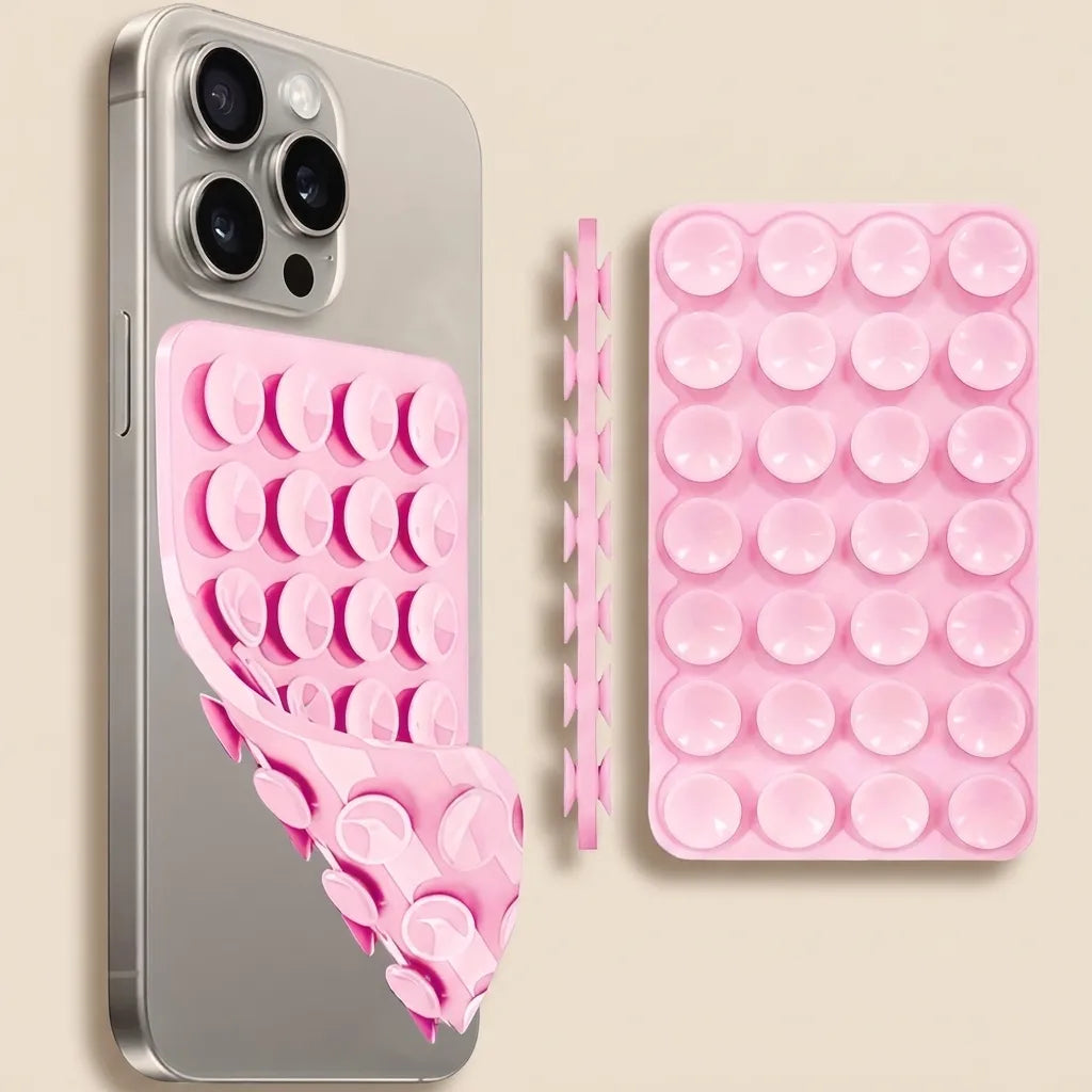 Pink silicone suction cup phone case shown installed on a silver smartphone, alongside the flat unrolled case and a separate strip of suction cups on a light beige background.