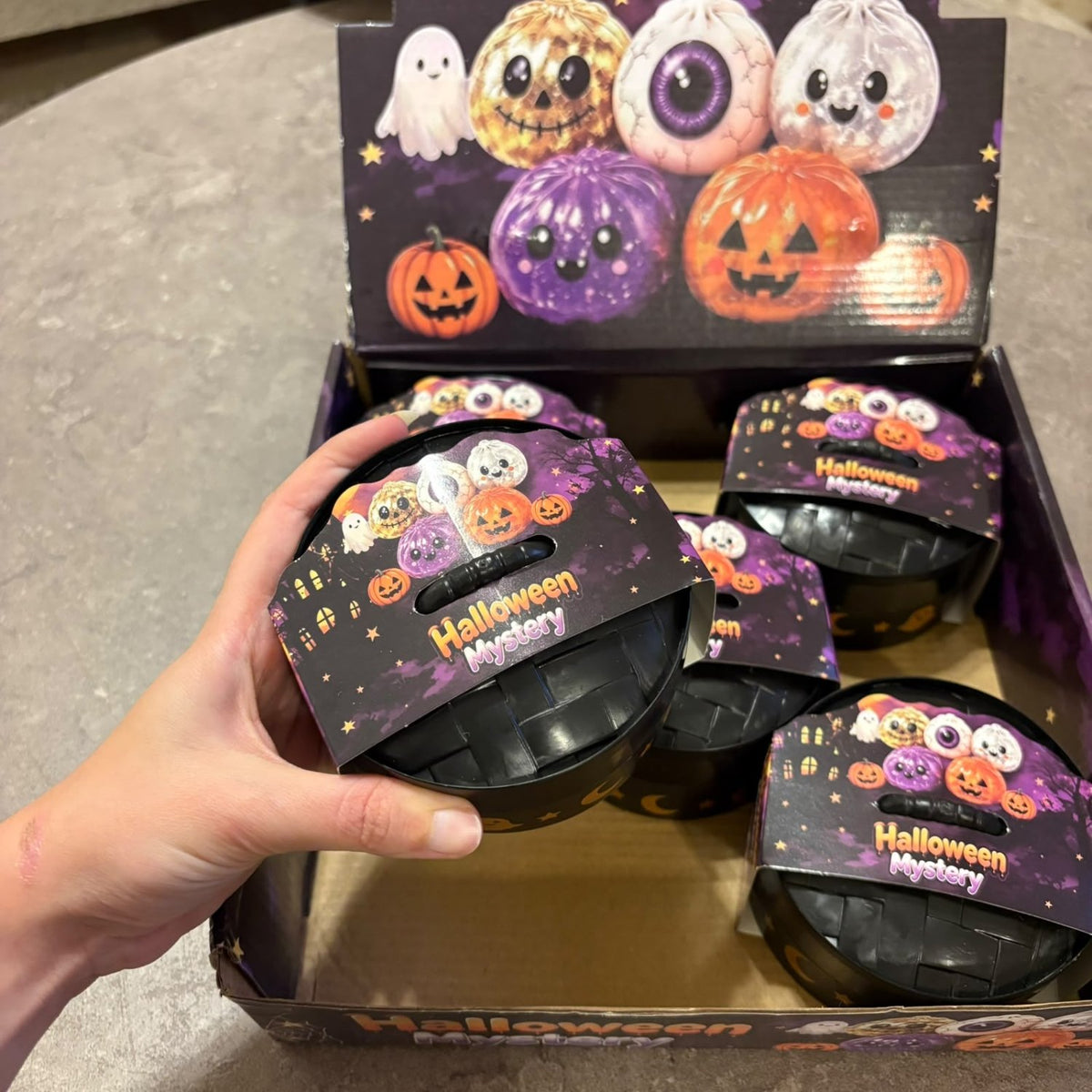 Glitter Dumpling Squishy Toy Halloween Edition blind box packaging, featuring a cute and stretchy novelty stress toy with sparkly glitter filling.