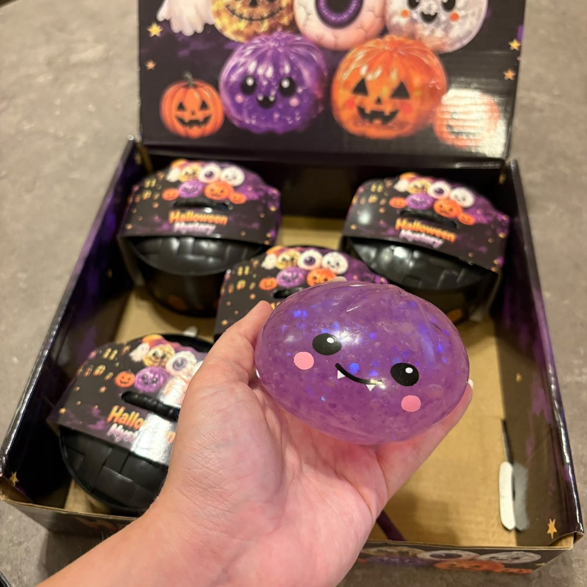Glitter Dumpling Squishy Toy Halloween Edition blind box packaging, featuring a cute and stretchy novelty stress toy with sparkly glitter filling.