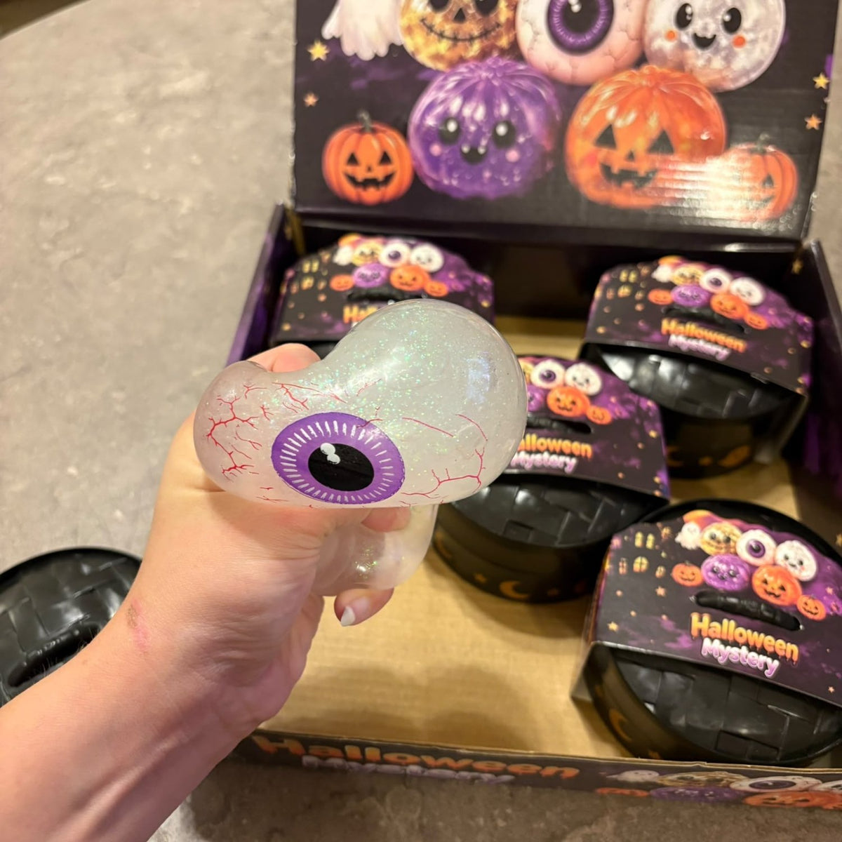 Glitter Dumpling Squishy Toy Halloween Edition blind box packaging, featuring a cute and stretchy novelty stress toy with sparkly glitter filling.