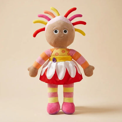 A plush toy doll with a round beige face, colorful hair in red, orange, yellow, and pink, wearing a red, white, and orange outfit with striped pink and yellow legs, standing against a solid beige background.