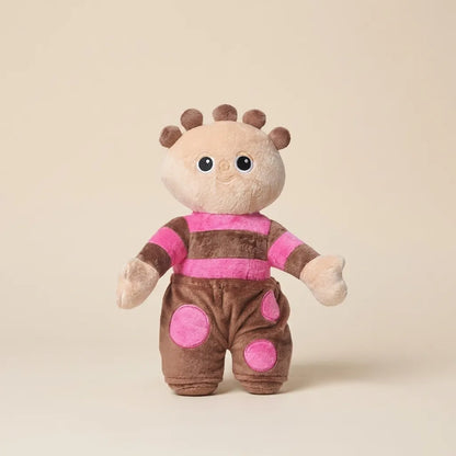 A plush toy doll with a beige face and hands, brown hair, and a pink-and-brown striped outfit with pink polka dots, standing against a plain beige background.